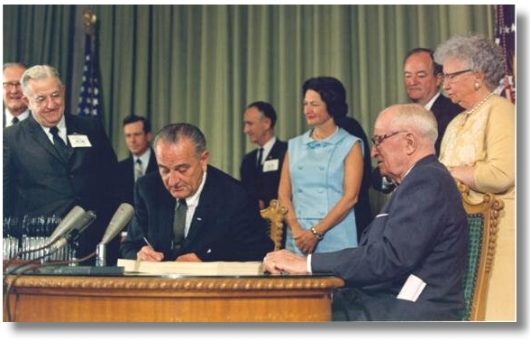 President Johnson signing Medicare into law