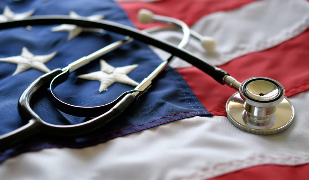 a United States of America flag with a stethoscope resting on top of it